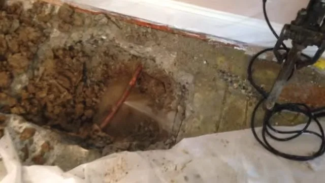 Acoustic sensor marking on brick floor, part of everyday plumbing calls around Austell, GA.