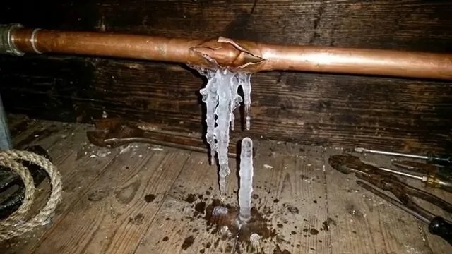 Burst copper pipe with hanging ice, part of everyday plumbing calls around Austell, GA.