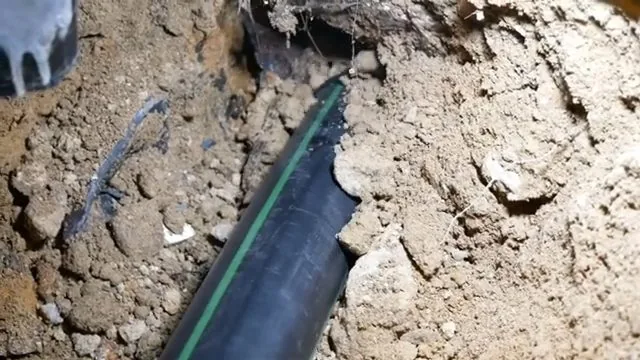 New black sewer pipe installed in slab trench, part of everyday plumbing calls around Austell, GA.